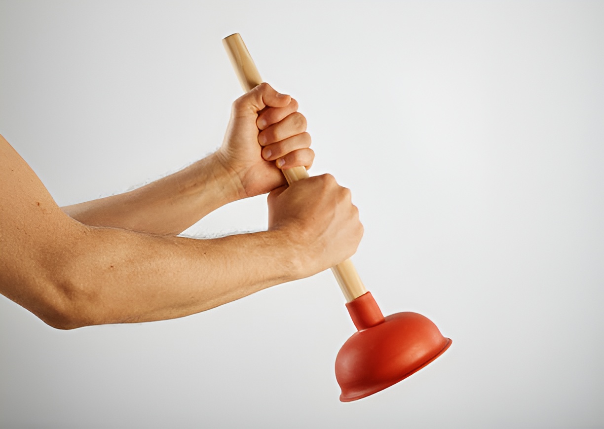 close-up of a man holding a plunger with both hands